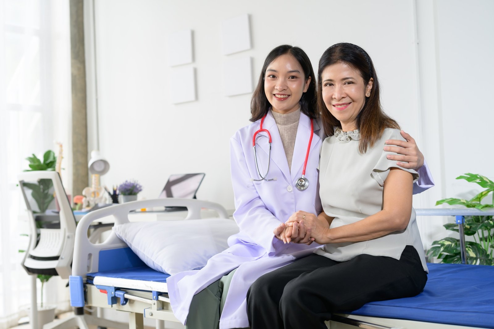 Female Doctor and Patient Smiling Together in a Hospital Room, Showing Compassionate Healthcare and