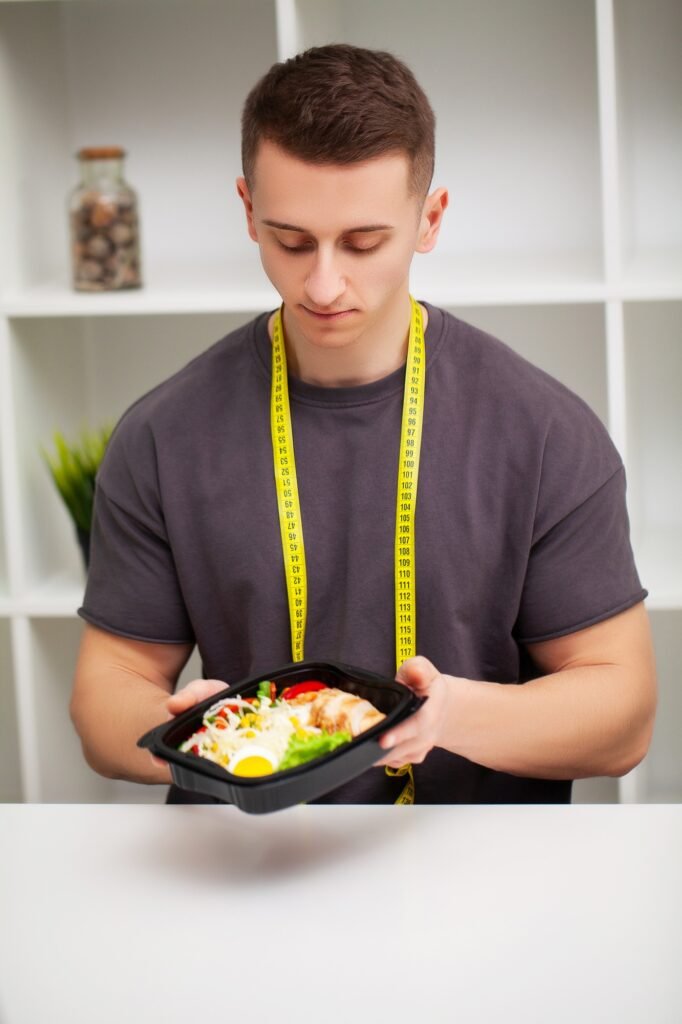 Man holding a box full of protein rich foods for sports nutrition